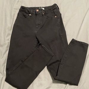 Good American slightly cropped black jeans with slits at ankle